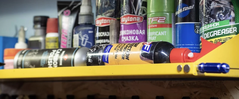 Marine maintenance products and consumables arranged together, including bottles, sprays, and lubricants.