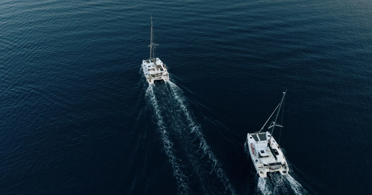 Two boats travelling across open water, viewed from above, illustrating vessel traffic and collision avoidance.