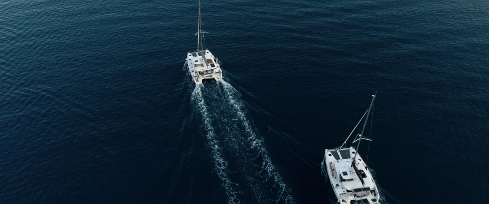 Two boats travelling across open water, viewed from above, illustrating vessel traffic and collision avoidance.