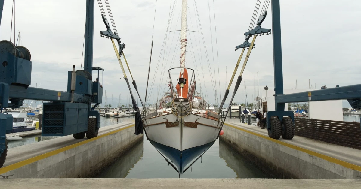 Sailboat hauled out in a boatyard at the end of the sailing season, ready for inspection and storage.