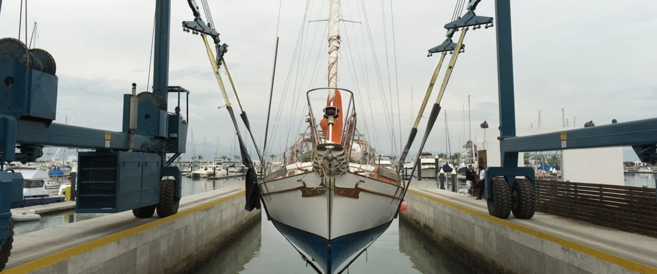 Sailboat hauled out in a boatyard at the end of the sailing season, ready for inspection and storage.