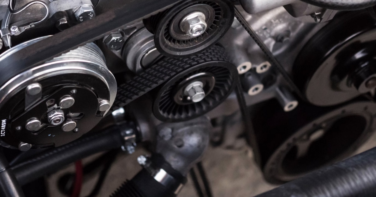 Close-up of a marine engine with belts and pulleys.