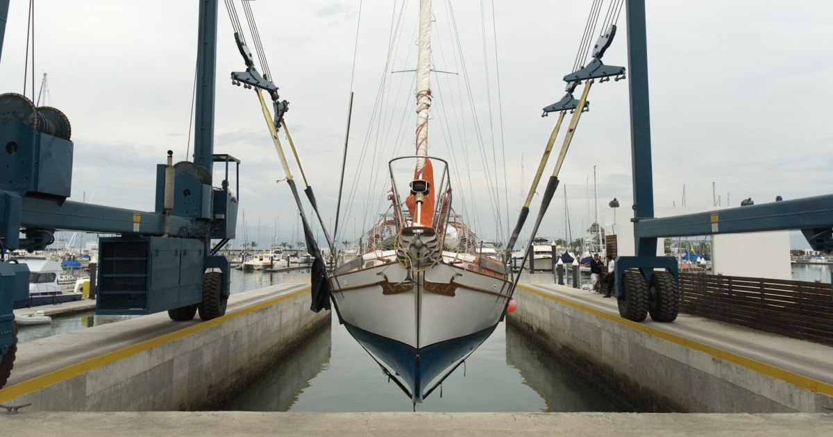 Sailboat hauled out in a boatyard at the end of the sailing season, ready for inspection and storage.