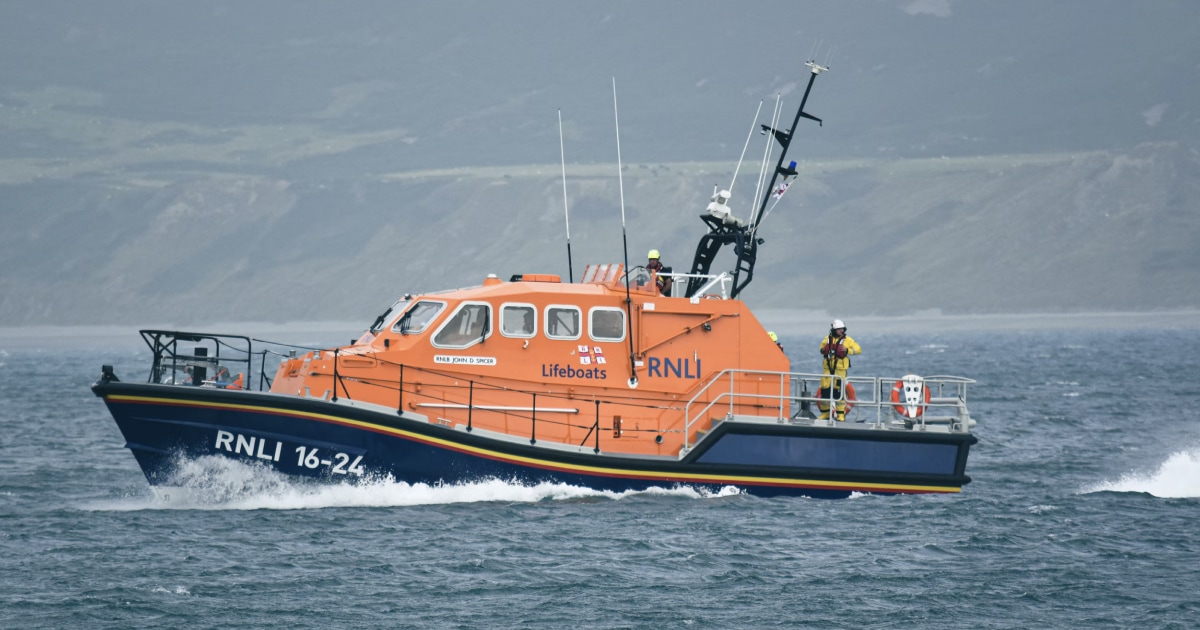 Orange rescue boat operating at sea, illustrating a maritime man-overboard response.
